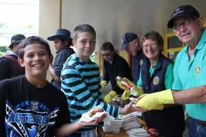 Enjoying the sausage sizzle lunch, from left, Flaxmere Primary School students Jaydus Hungahunga (face obscured), Kayden Meston, Elijah Ioane and J R Anderson and Rotarians Chris Price, Peter Warren, Carol Charman and Robert Pearson