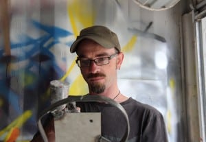 Screen production design lecturer Jonathan Brough adds the finishing touches to a prop in ideaschool’s spray booth.
