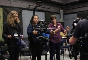 Aliesha Staples (right) demonstrates the action needed to operate a gimballed camera to AWA Transmedia Studios camera operator and ideaschool graduate Floyd Pepper (left) and current screen production student Skylah Rewi. 