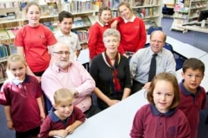 Figure 55: Dennis Coxon (left) Principal of Taradale Intermediate School (TIS) and Gwenda Kevern (right) HOD of Education and Social Sciences surrounded by students from TIS and Frimley Primary School.